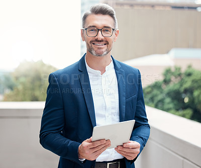 Buy stock photo Portrait of a mature businessman using a digital tablet outside