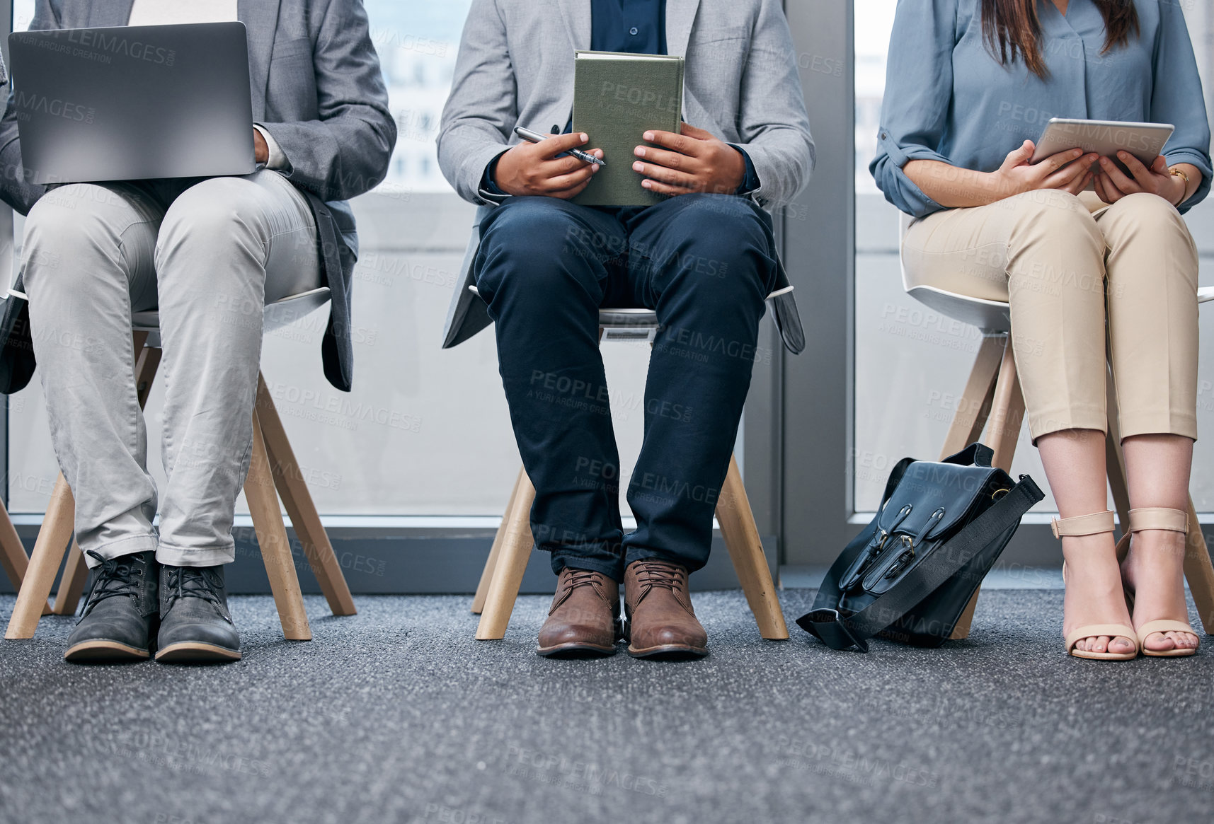 Buy stock photo Recruitment, row and business people waiting in office with tablet, laptop and notebook for meeting. Hr, career and legs of job candidates sitting in line for interview with technology in workplace.
