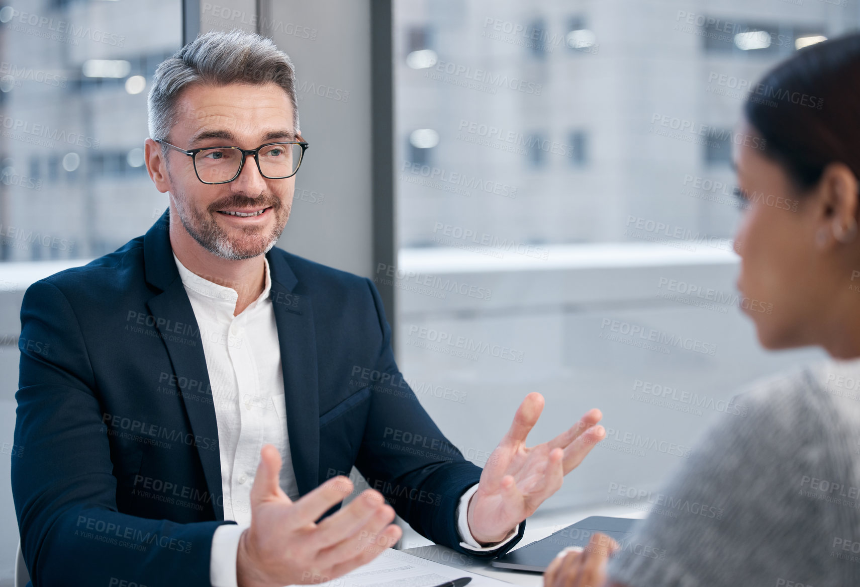 Buy stock photo Shot of two businesspeople talking in an office