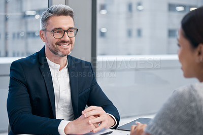 Buy stock photo Shot of two businesspeople talking in an office