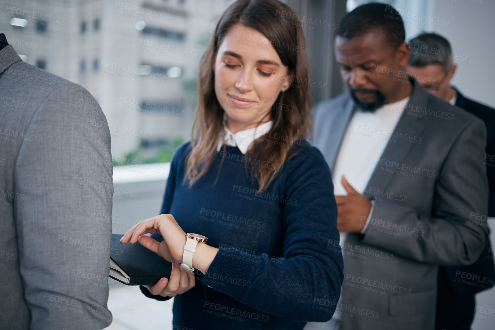 Buy stock photo Shot of a young businesswoman looking at a watch in a waiting room