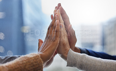 Buy stock photo Shot of a group of businesspeople high fiving each other