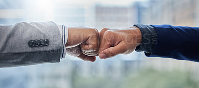 Buy stock photo Shot of two businesspeople fist bumping one another