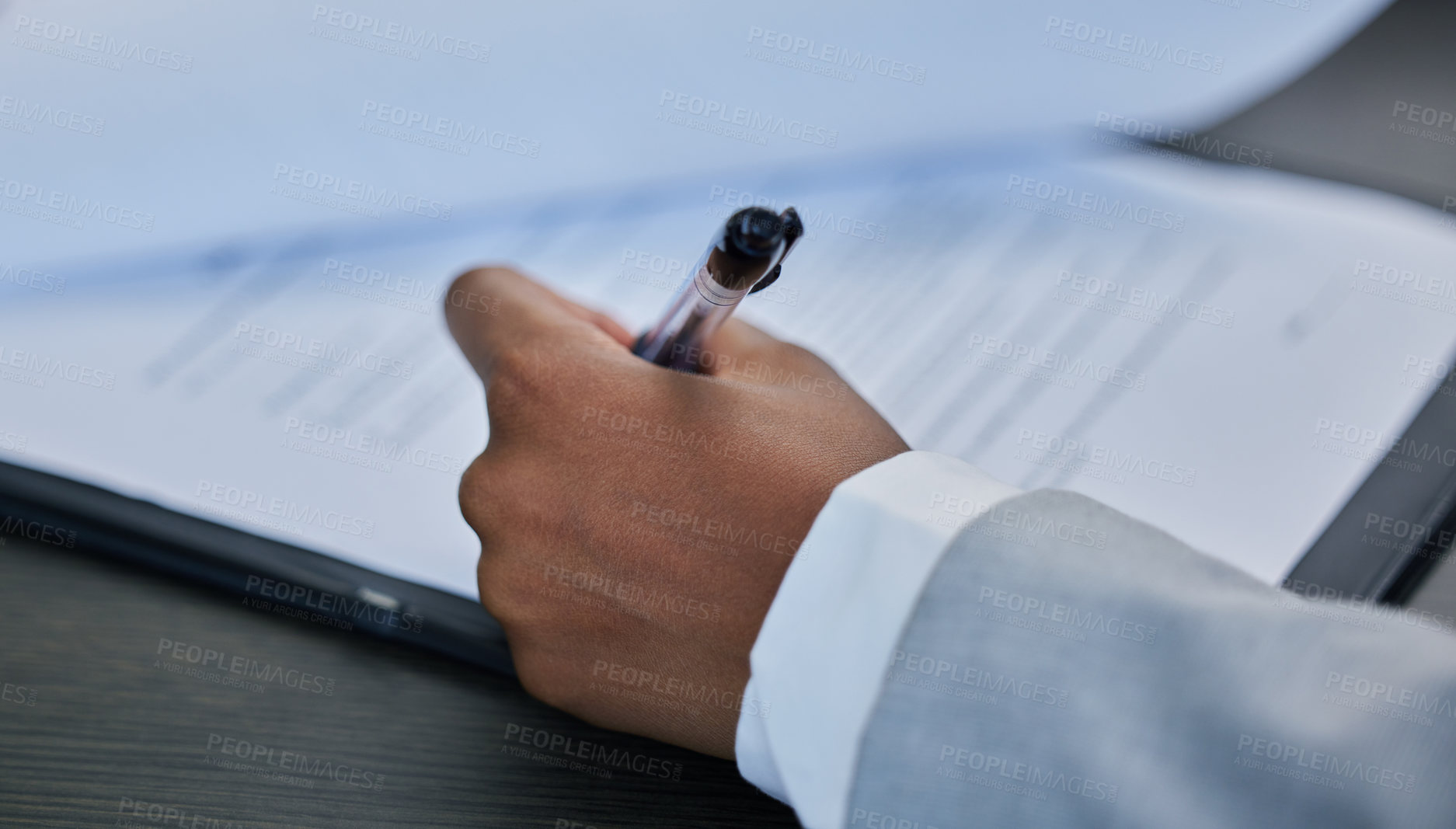 Buy stock photo Shot of s businessman filling out paperwork in his office