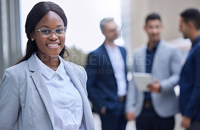 Buy stock photo Cropped portrait of an attractive young businesswoman standing outside with her colleagues in the background