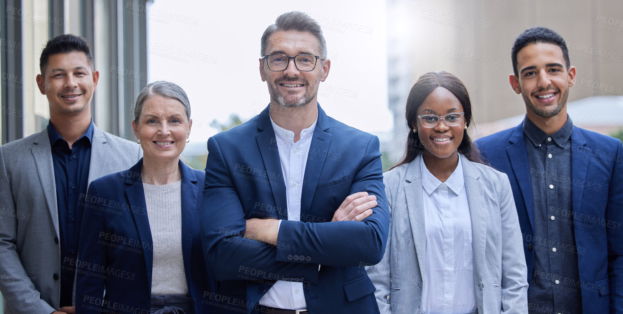 Buy stock photo Cropped portrait of a group of corporate businesspeople standing outside with their arms folded