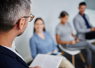 Buy stock photo Shot of a mature businessman calling in the next candidate for a job interview in a modern office
