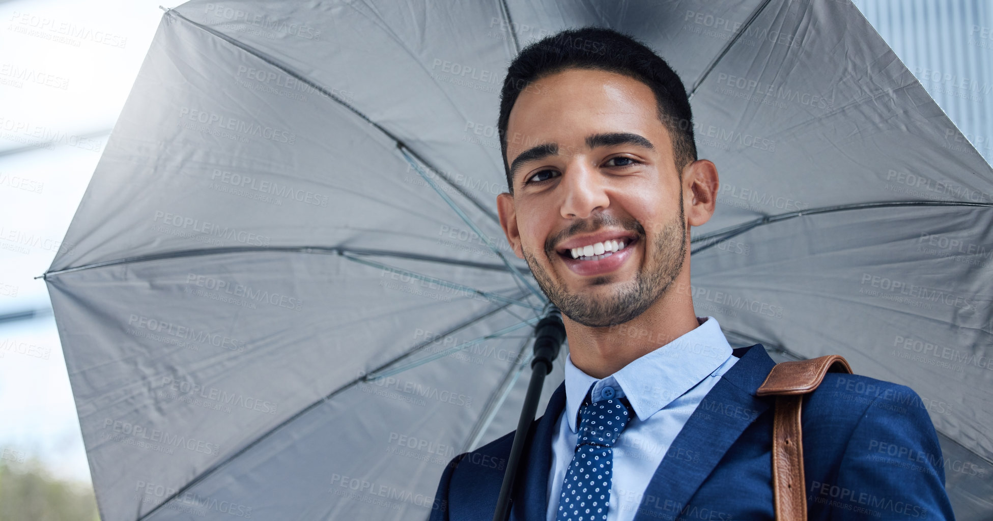 Buy stock photo Businessman, portrait or umbrella with smile in city for justice, advocate for legal at building. Male lawyer, rain or parasol for safety in urban with happiness, attorney in New York for court