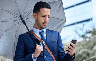 Buy stock photo Businessman, phone and umbrella with communication in city for justice, advocate for legal with tech. Male lawyer, rain or parasol for safety in urban with mobile, attorney in New York for court