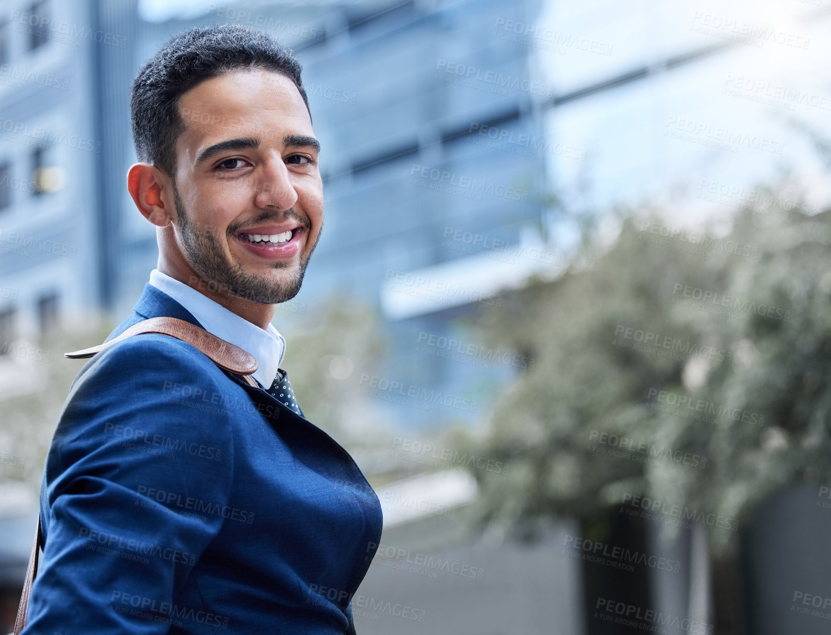 Buy stock photo Cropped portrait of a handsome young businessman on his morning commute into work