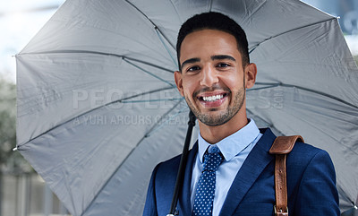 Buy stock photo Cropped portrait of a handsome young businessman with an umbrella on his morning commute into work