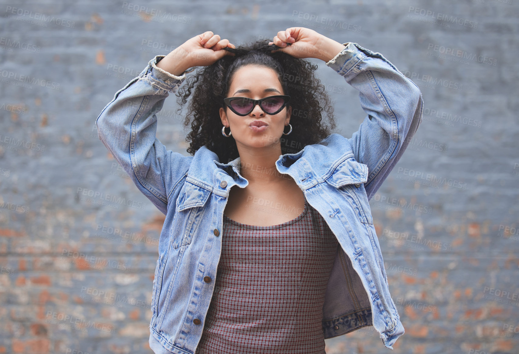 Buy stock photo Fashion, attitude and portrait of woman on wall background in trendy, stylish and urban clothes. Beauty, freedom and happy female person pose in city with sunglasses, confidence and style outdoors