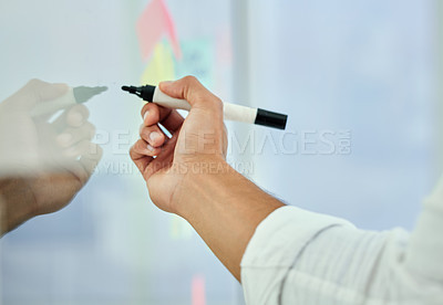Buy stock photo Cropped shot of an unrecognizable businessman working on a glass wipe board in his office