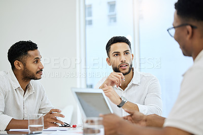 Buy stock photo Cropped shot of a group of young diverse businessmen having a meeting in the boardroom