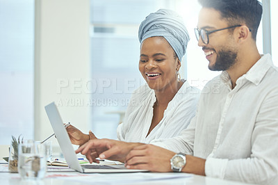 Buy stock photo Cropped shot of two young diverse businesspeople working together on a laptop in their office