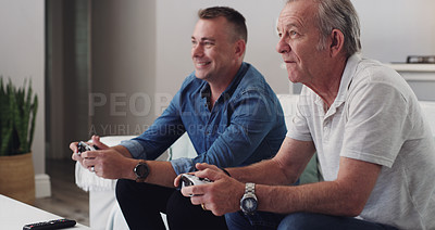 Buy stock photo Shot of a father and son bonding over video games