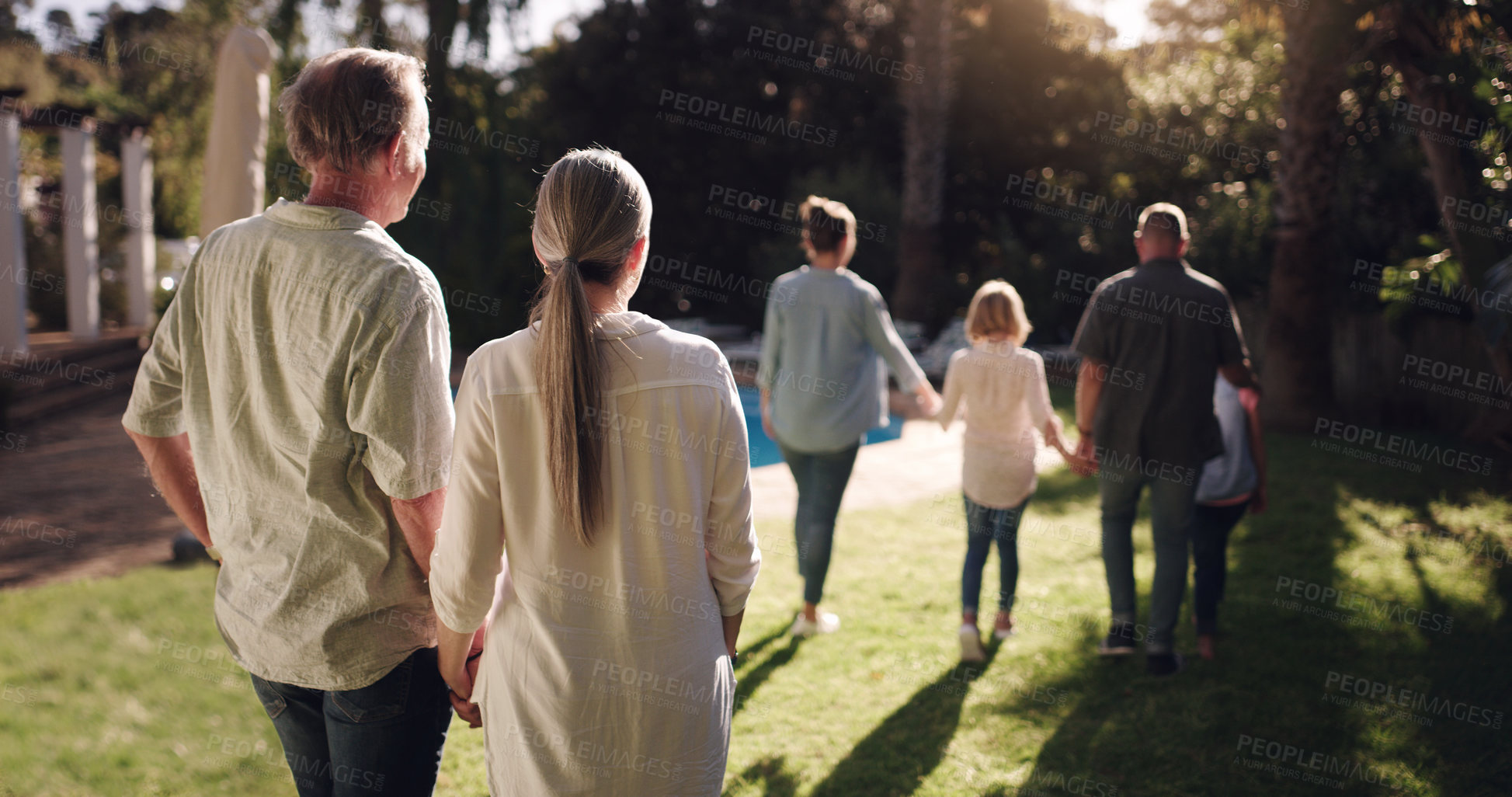 Buy stock photo Big family, love and walking together in garden for sunset, bonding and peace in nature. Grandmother, grandfather and kids in park or backyard for happiness, view and satisfied with life or journey