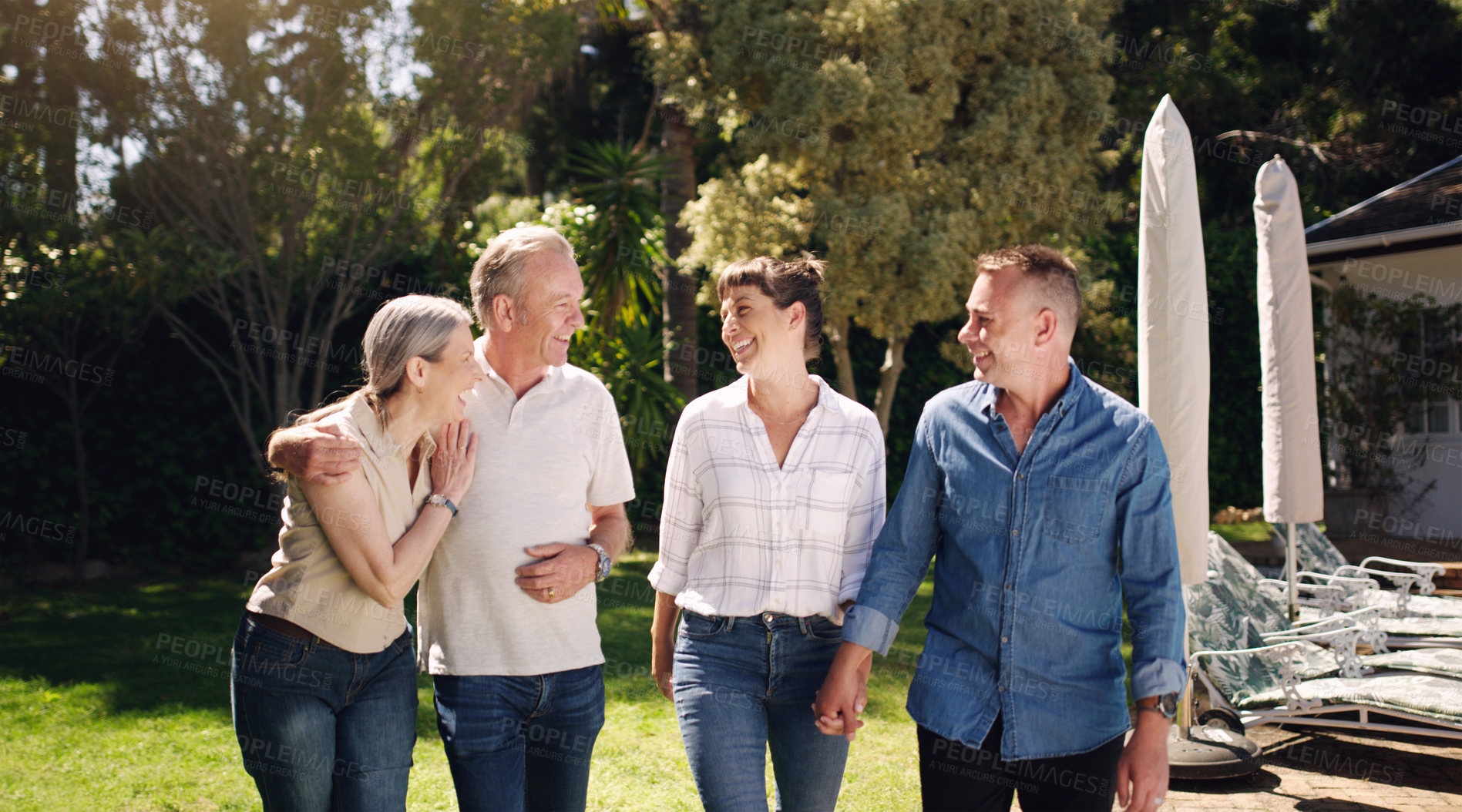 Buy stock photo Grandparents, parents and happy with smile in backyard  together for love, summer and vacation. Big family, laughing and walking in garden for double date, bonding and holiday resort with peace
