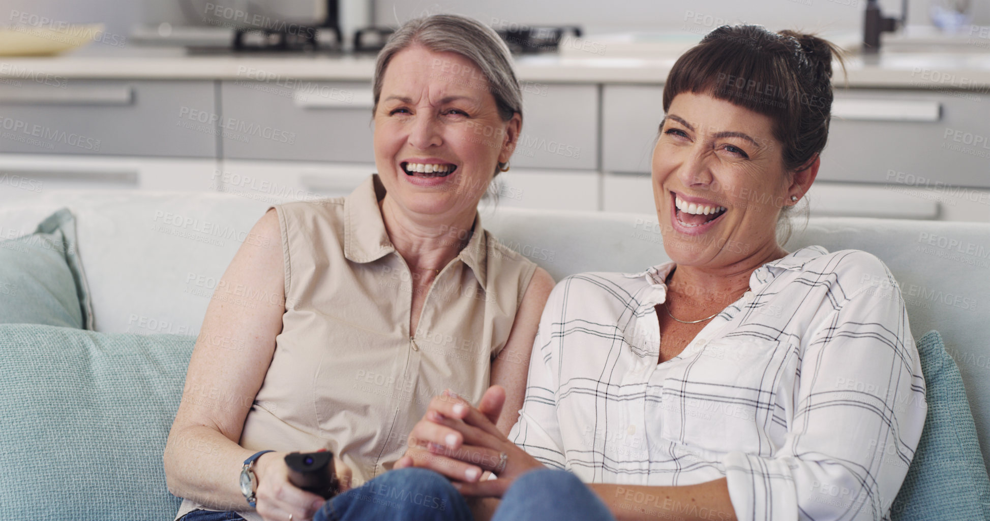 Buy stock photo Shot of s mother and daughter enjoying a TV show together