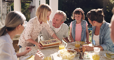 Buy stock photo Shot of a grandfather celebrating his birthday with his grandchildren at home