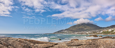 Buy stock photo Copy space, sea and ocean view of beach waves washing onto rocks on empty, relaxing tropical coast with mountain background. Seascape, blue sky and tidal water on a remote and secluded coastal island