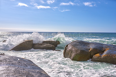 Buy stock photo Scenic ocean view of beach with rocks or boulders and sea water washing onto shore during peaceful summer vacation in tropical resort and island overseas. Rough texture and detail of rocky coastline