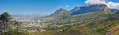 Buy stock photo Panoramic landscape view of the majestic Table Mountain and city of Cape Town in South Africa. Beautiful scenery of a popular tourist destination and national landmark with cloudy blue sky copy space