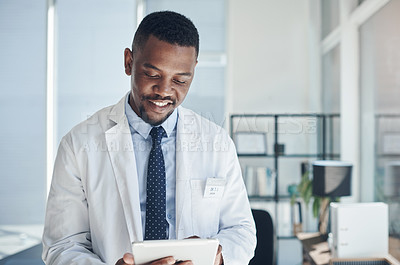 Buy stock photo Reading, doctor and black man with tablet, smile and telehealth in clinic, web and online for healthcare. Workplace, hospital and internet for technology, medical and science for research of staff