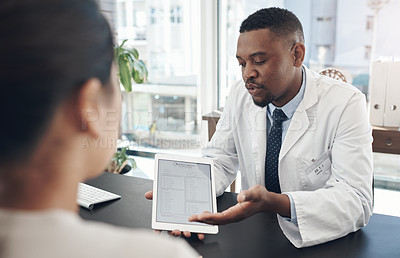 Buy stock photo Shot of a young male doctor talking to a patient about a survey in an office