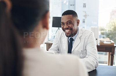Buy stock photo Shot of a young male doctor talking to a patient in an office
