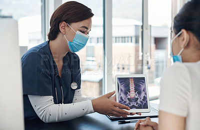Buy stock photo Shot of a young female doctor showing a patient a digital x-ray in an office