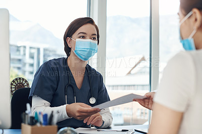 Buy stock photo Shot of a young female doctor giving a patient a document in an office