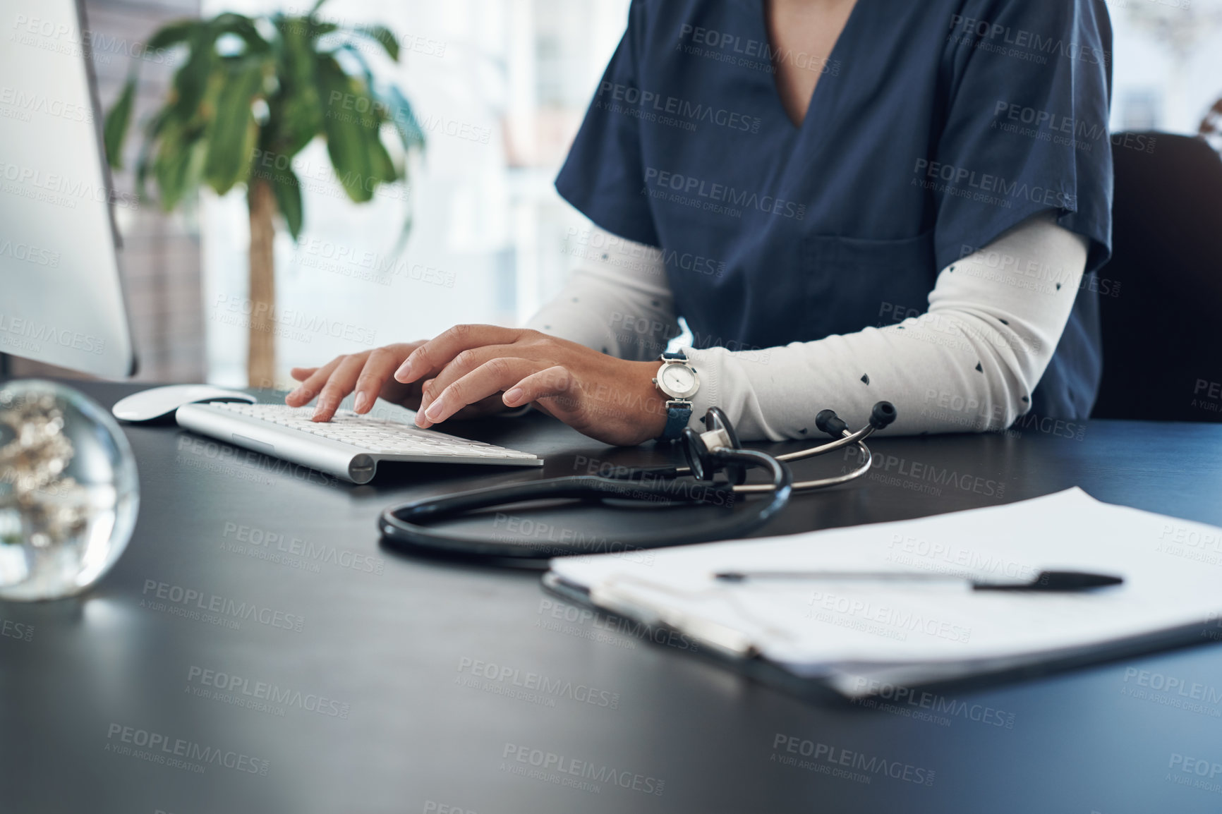 Buy stock photo Shot of an unrecognizable doctor using computer in an office