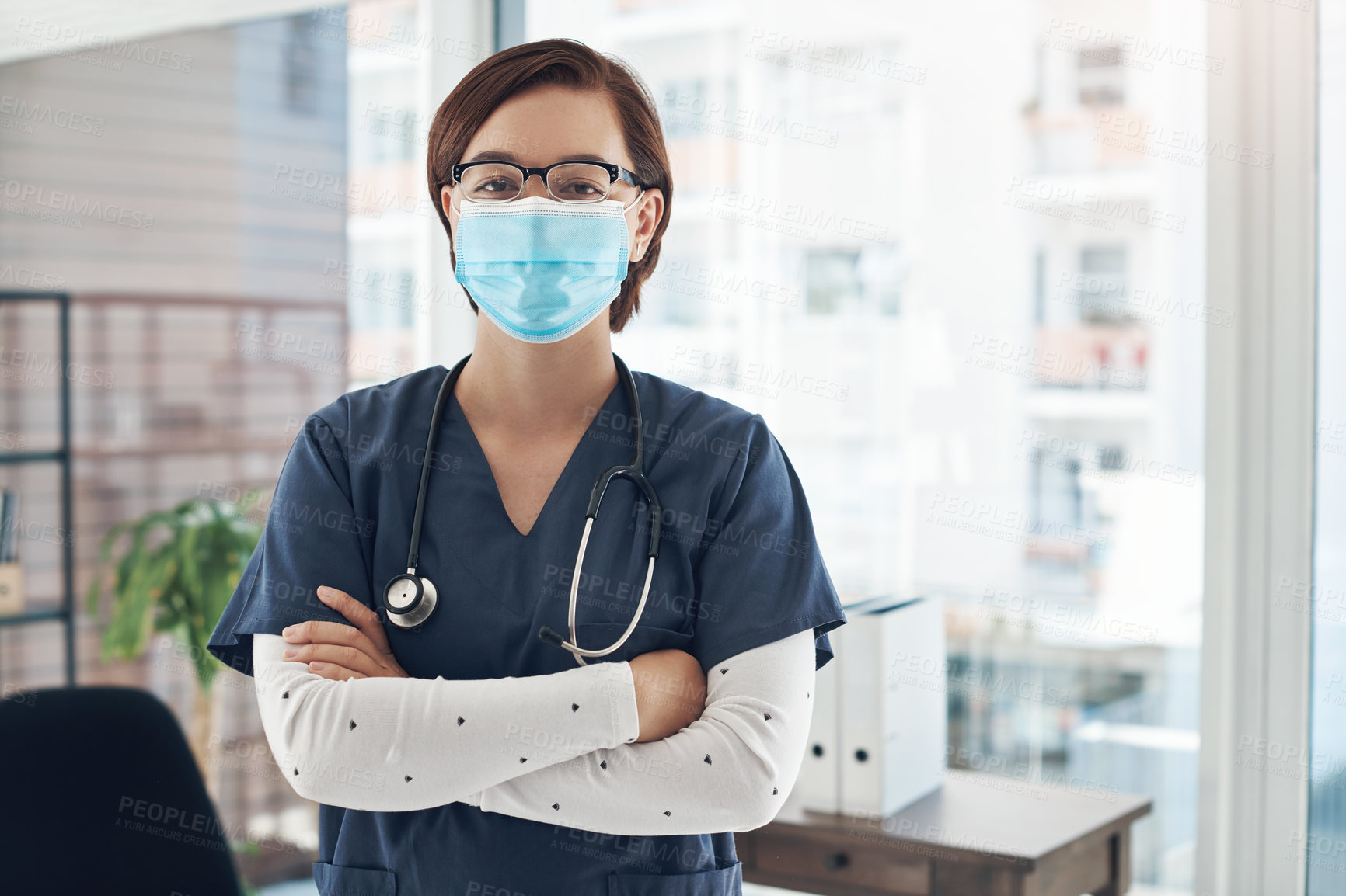 Buy stock photo Portrait, woman and doctor with arms crossed, mask and healthcare with career ambition in hospital. Person, medical or professional with face cover, proud and confidence with virus, safety or protect