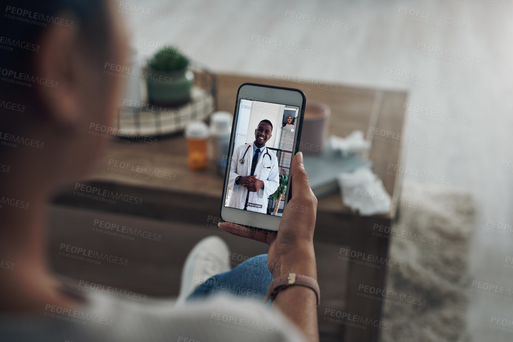 Buy stock photo Shot of an unrecognizable person on a videocall with a doctor