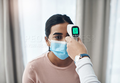 Buy stock photo Shot of an unrecognizable doctor using a thermometer to take a patient's temperature in an office