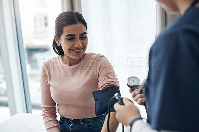 Buy stock photo Blood pressure, woman and health check with a smile at a clinic and healthcare hospital with doctor. Monitor, checking and nurse with young female patient at a wellness and medical consultation 