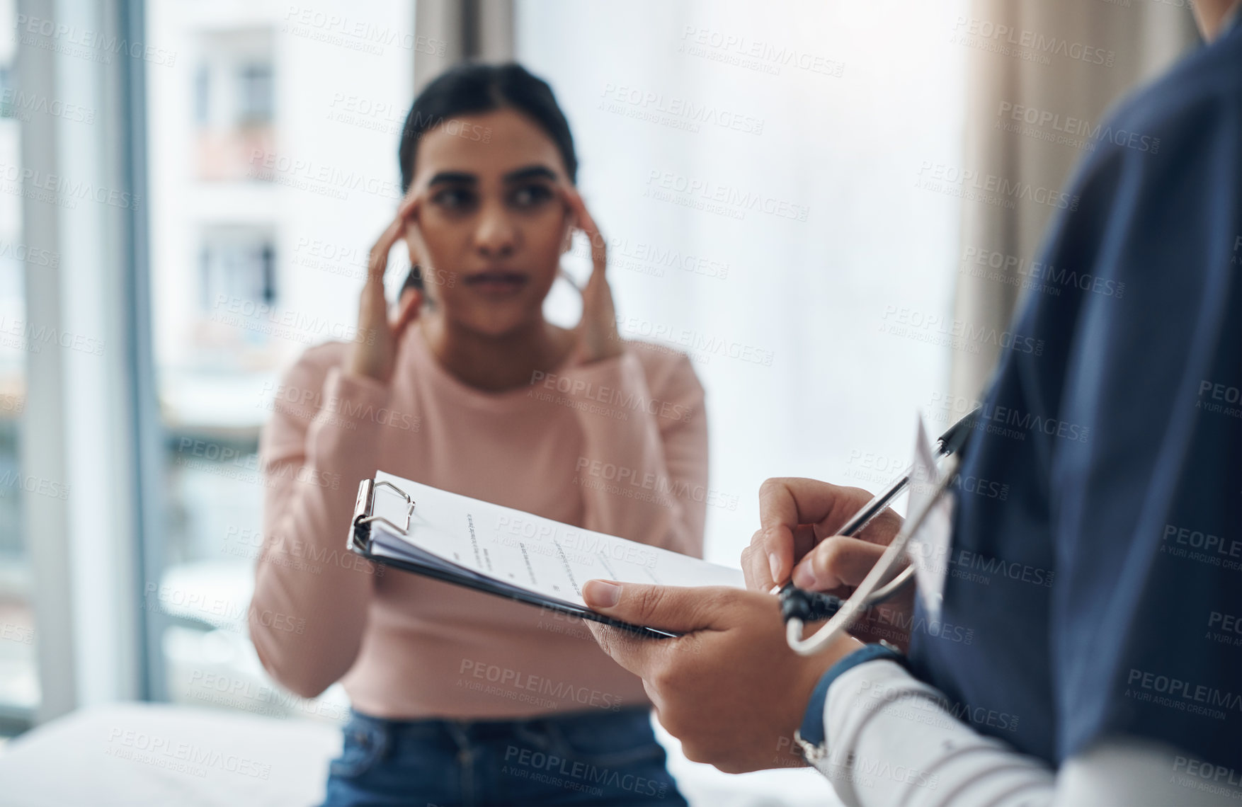 Buy stock photo Shot of an unrecognizable doctor writing down a patient's information in an office