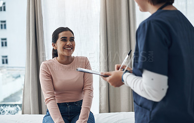 Buy stock photo Shot of an unrecognizable doctor writing down a patient's information in an office