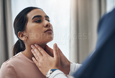Buy stock photo Shot of an unrecognizable doctor feeling a patient's throat in an office