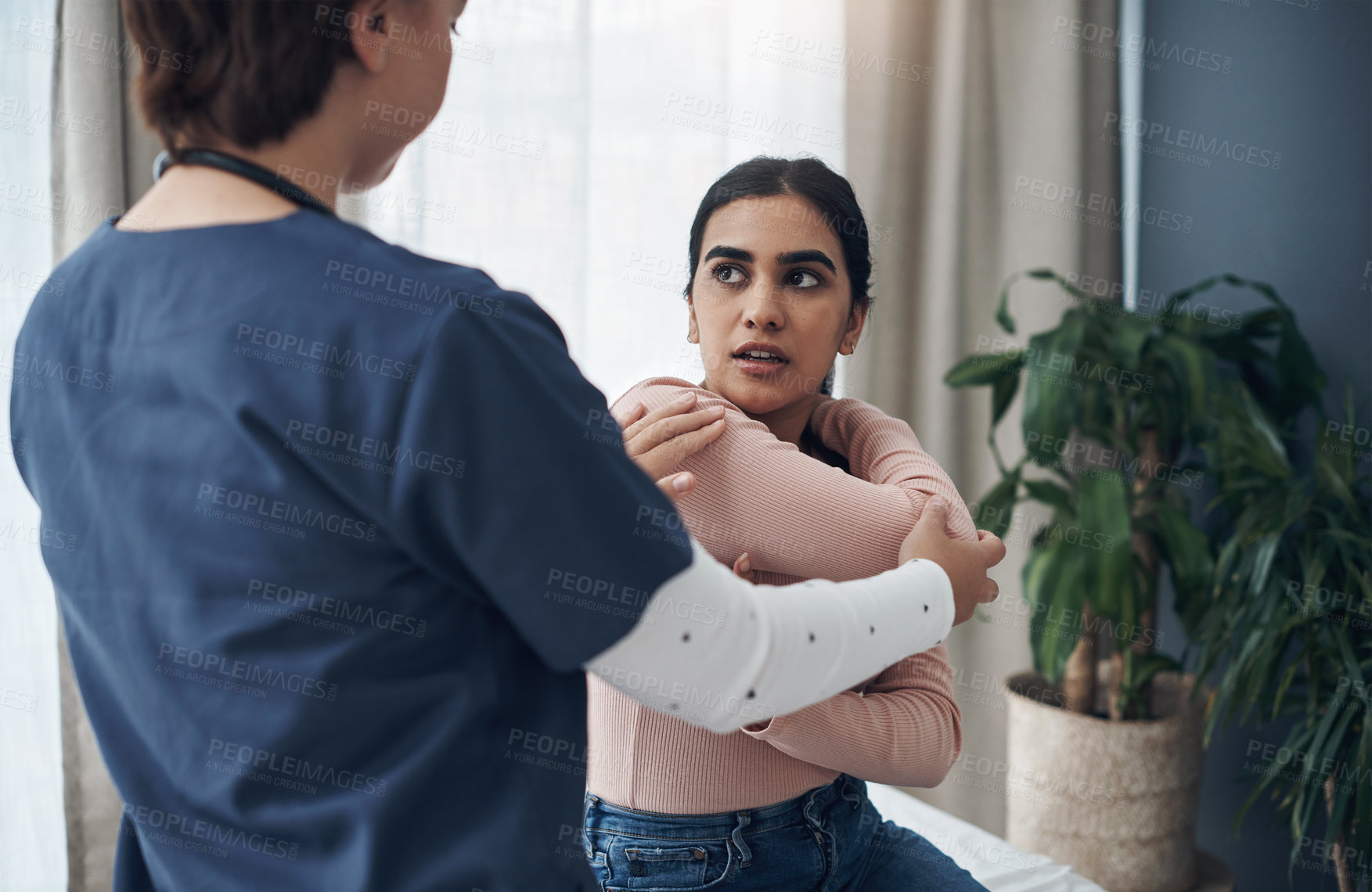 Buy stock photo Female doctor, patient and arm pain in office for consult, check and diagnosis in clinic. Woman, girl and examination for distress on body, shoulder or elbow for physio therapy, treatment and relief