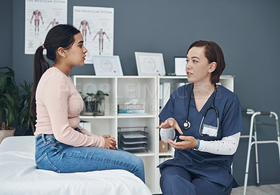 Buy stock photo Shot of a young female doctor talking to a patient in an office