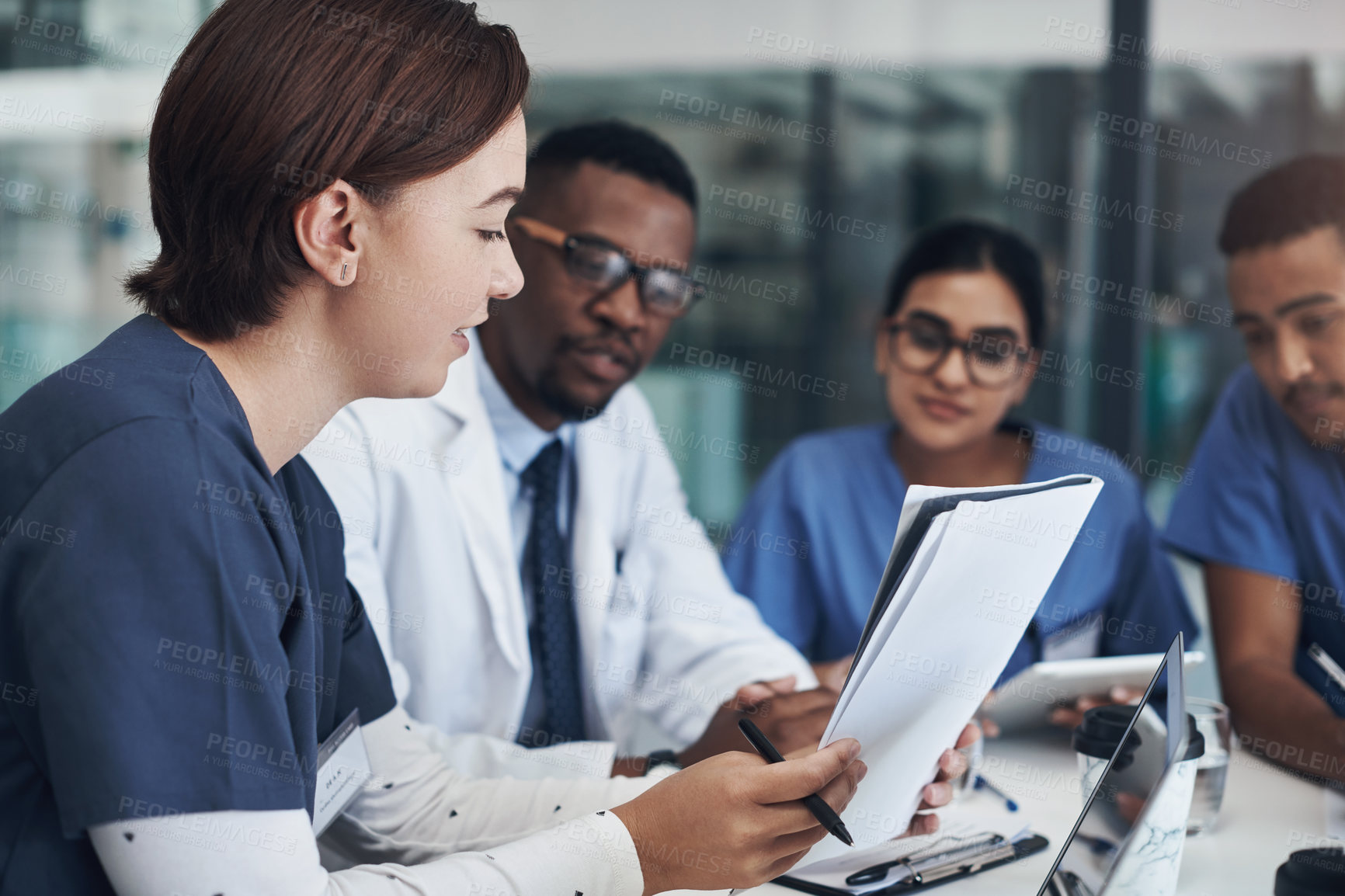 Buy stock photo Shot of a group of nurses and doctors having a meeting together