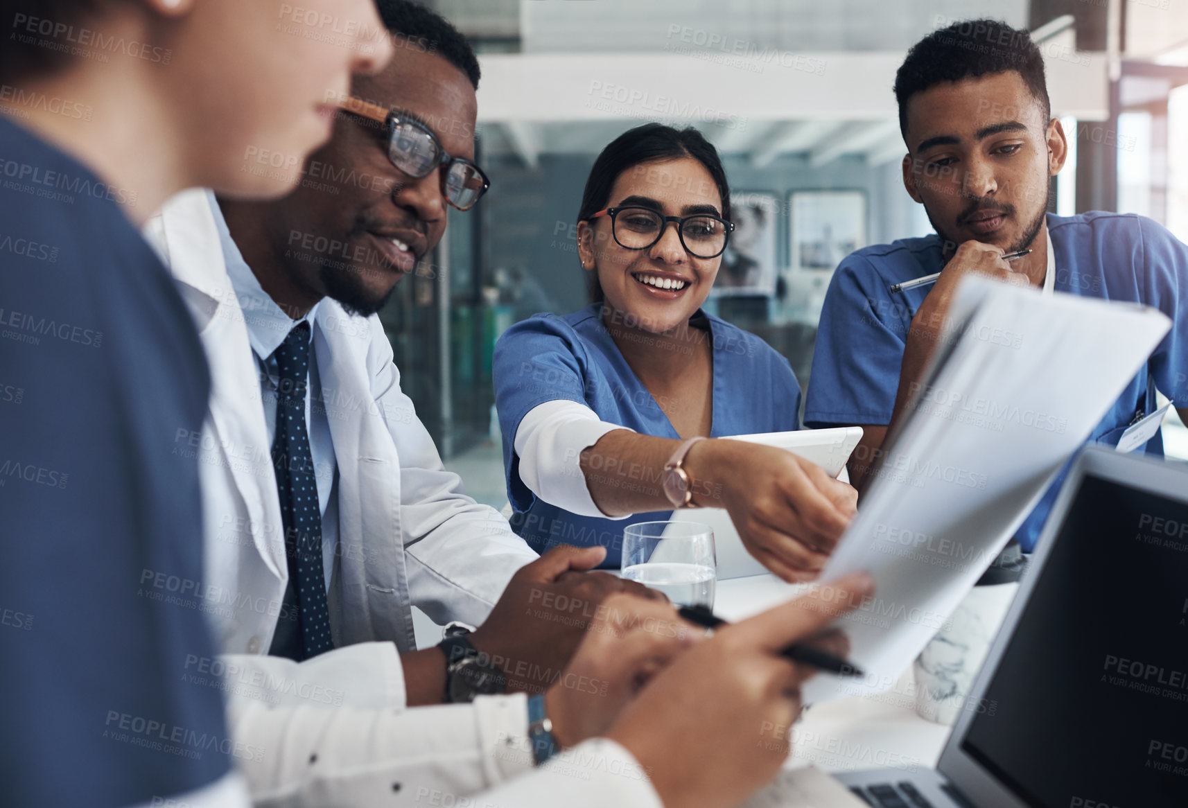 Buy stock photo Meeting, paperwork and team of doctors in office for medical treatment, diagnosis or surgery plan in clinic. Discussion, documents and surgeon with group of healthcare interns learning in hospital.