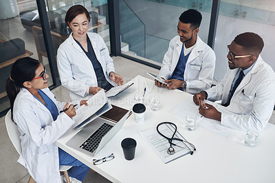 Buy stock photo Shot of a group of doctors having a meeting together