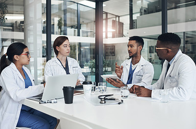 Buy stock photo Shot of a group of doctors having a meeting together