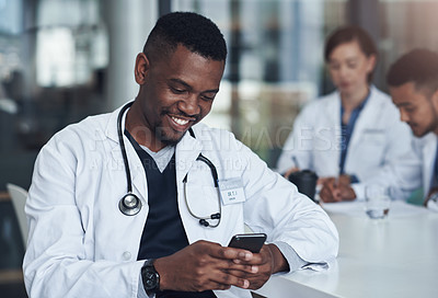 Buy stock photo Typing, phone and doctor with smile in hospital for network, healthcare website and research. Medical professional, office and man with smartphone for digital consulting, service and telehealth