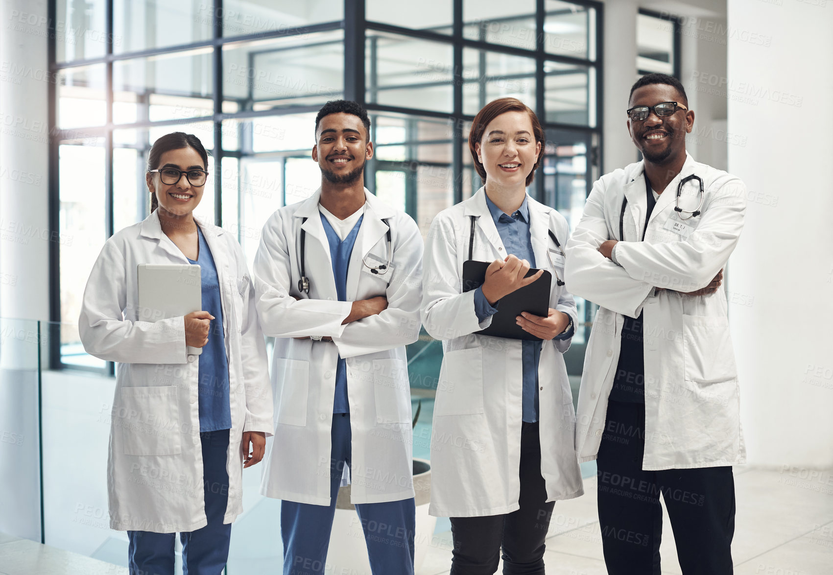 Buy stock photo Doctors, smile and portrait in hospital standing with arms crossed for health care, wellness and solidarity. Clinic, surgeons or physicians together for medical advice, teamwork or collaboration