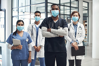 Buy stock photo Shot of a group of doctors and nurses wearing face masks to protect from illness