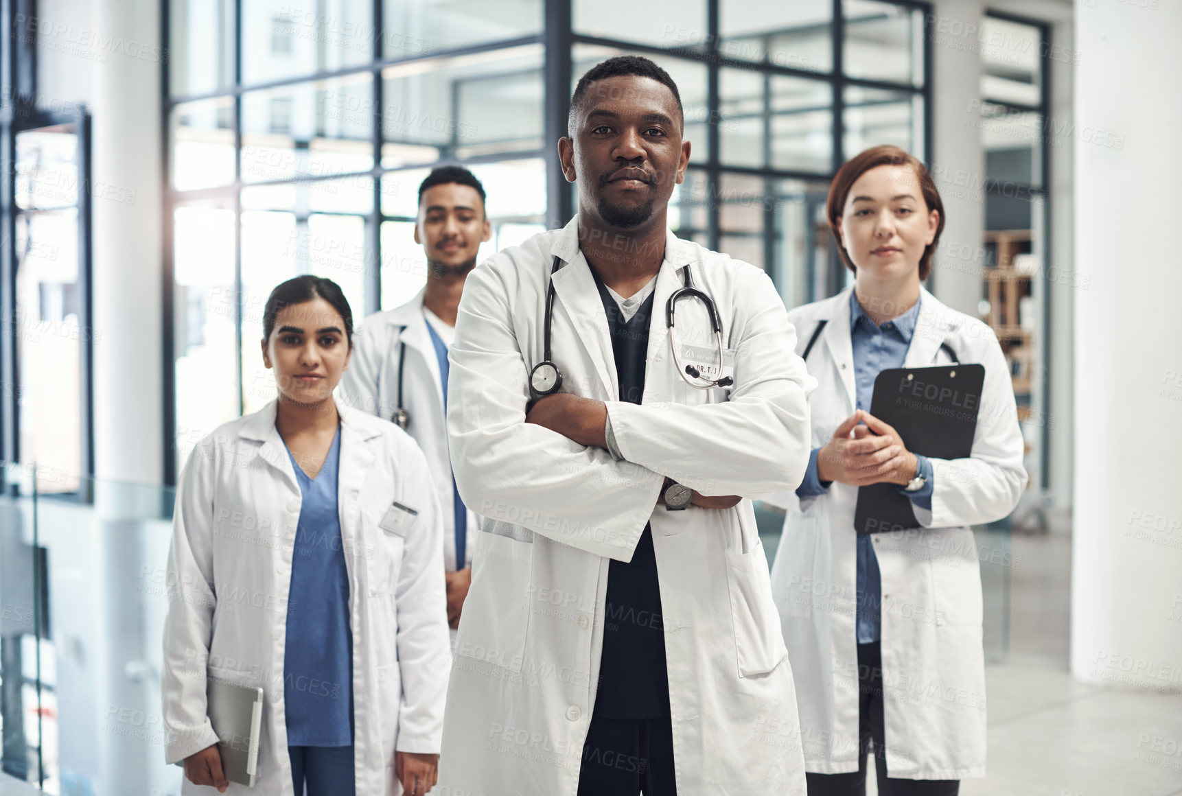 Buy stock photo Diversity, doctors and portrait with pride in hospital for collaboration with healthcare, help and advice. Black man, global staff and teamwork in clinic with stethoscope, medical job and confidence